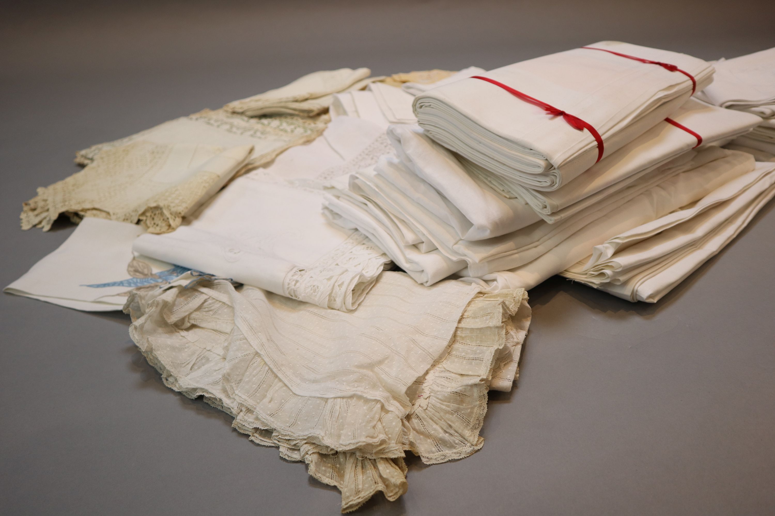 A quantity of linen sheets and embroidery